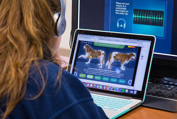 student in headphones using Murmur Learner app on a laptop