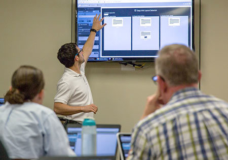 CET staff member demonstrating Stepstone on a large monitor